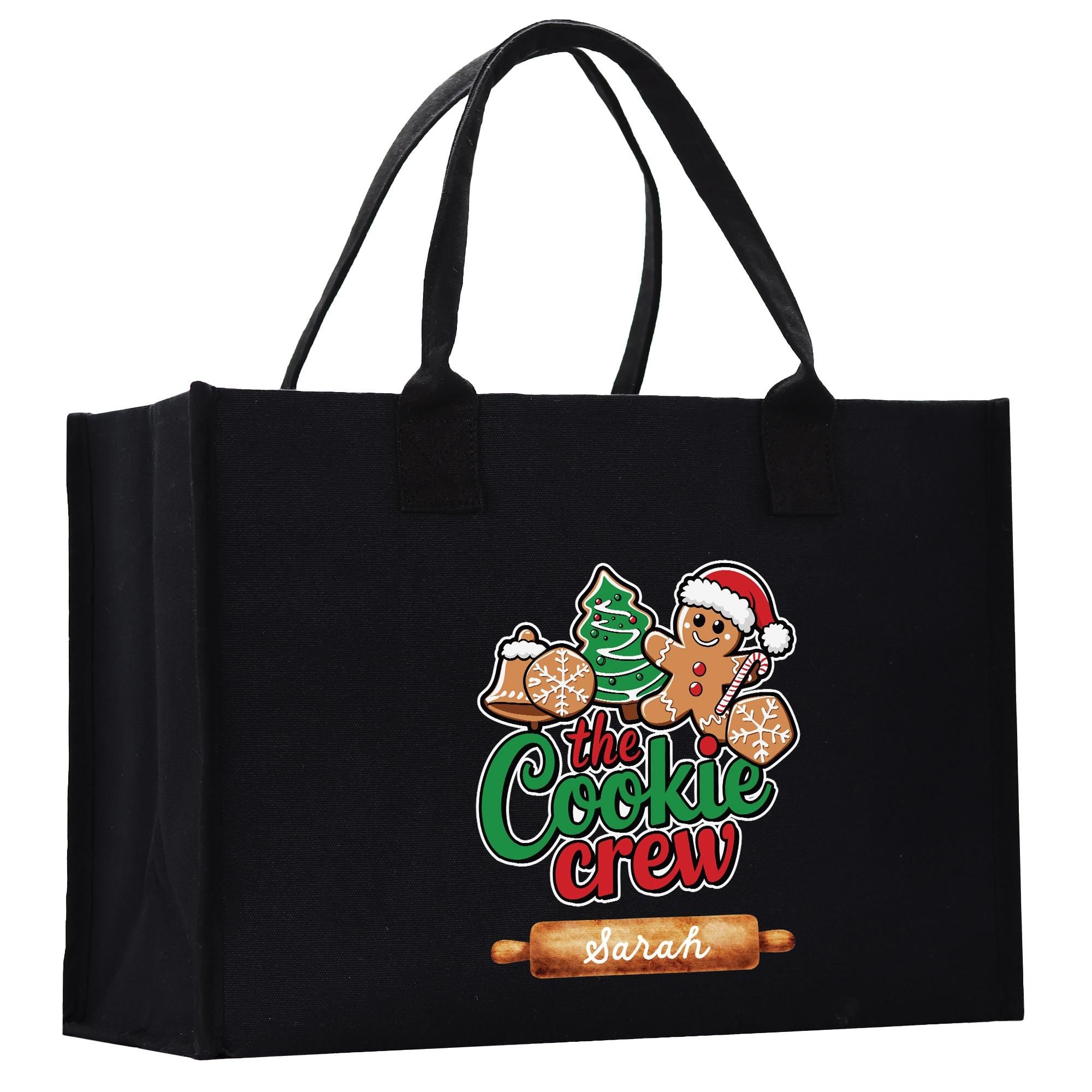 A black tote bag with a colorful graphic design featuring a gingerbread man and the text &quot;The Cookie Crew&quot; printed on it.