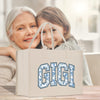 an older woman and young girl holding a shopping bag