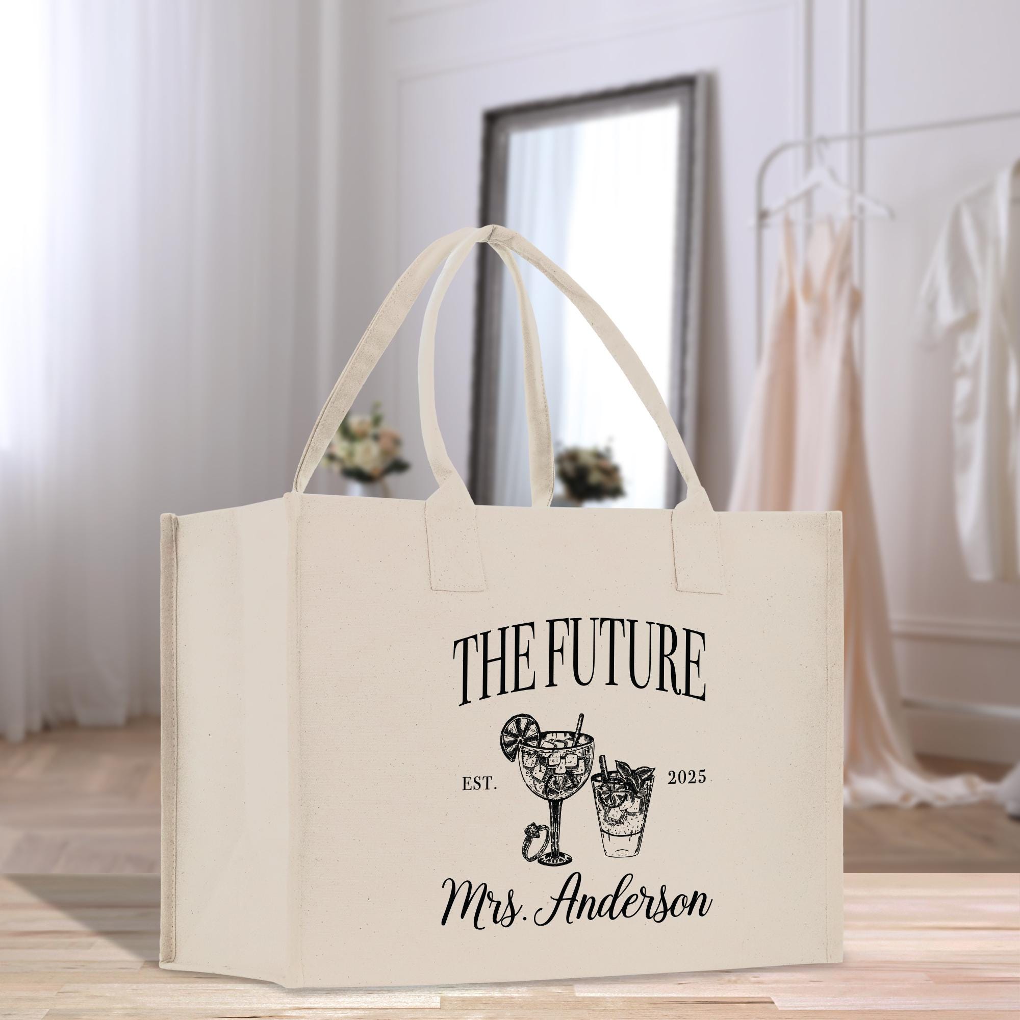 a white tote bag sitting on top of a wooden floor
