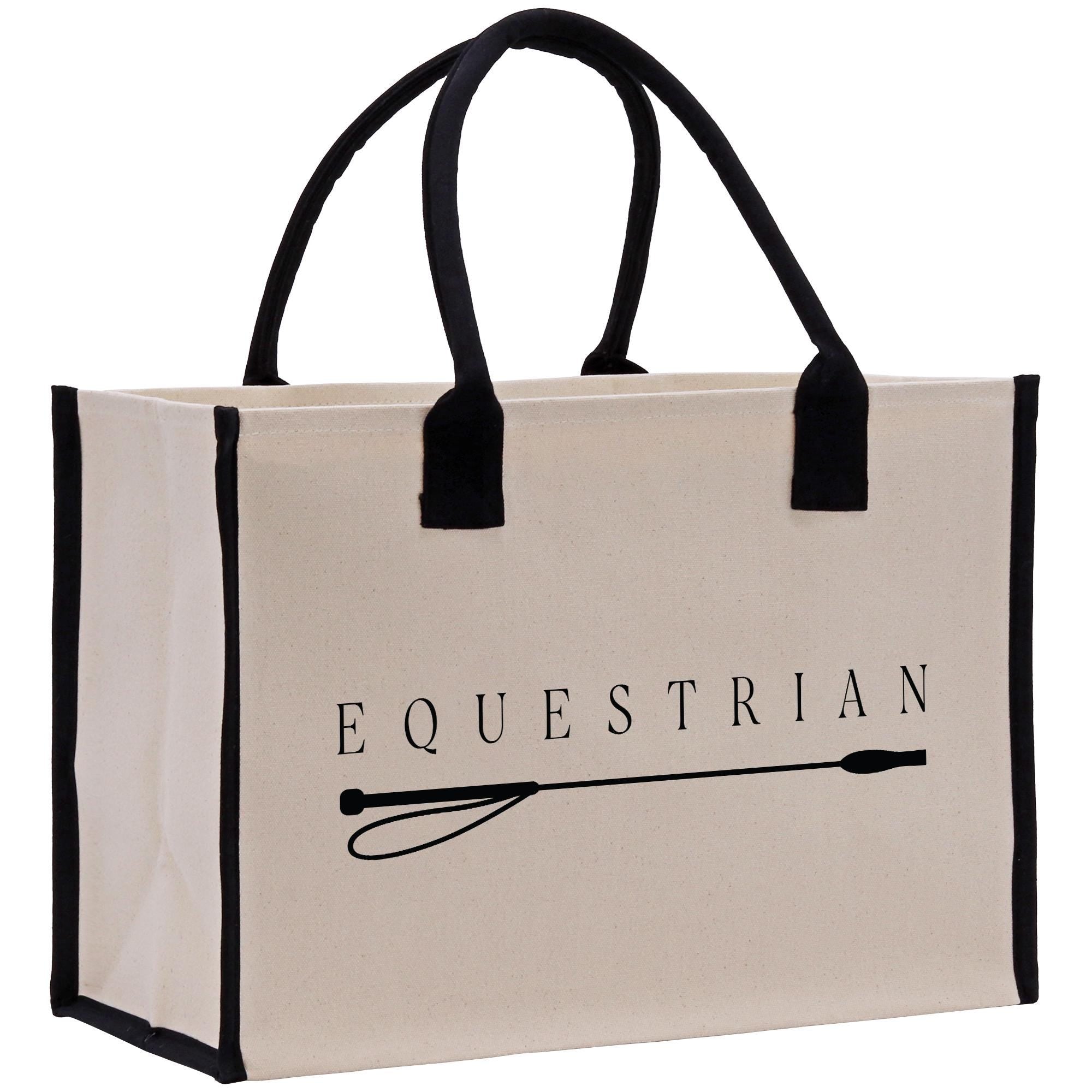 A beige canvas tote bag with black handles and trim, featuring the word &quot;EQUESTRIAN&quot; printed on it.