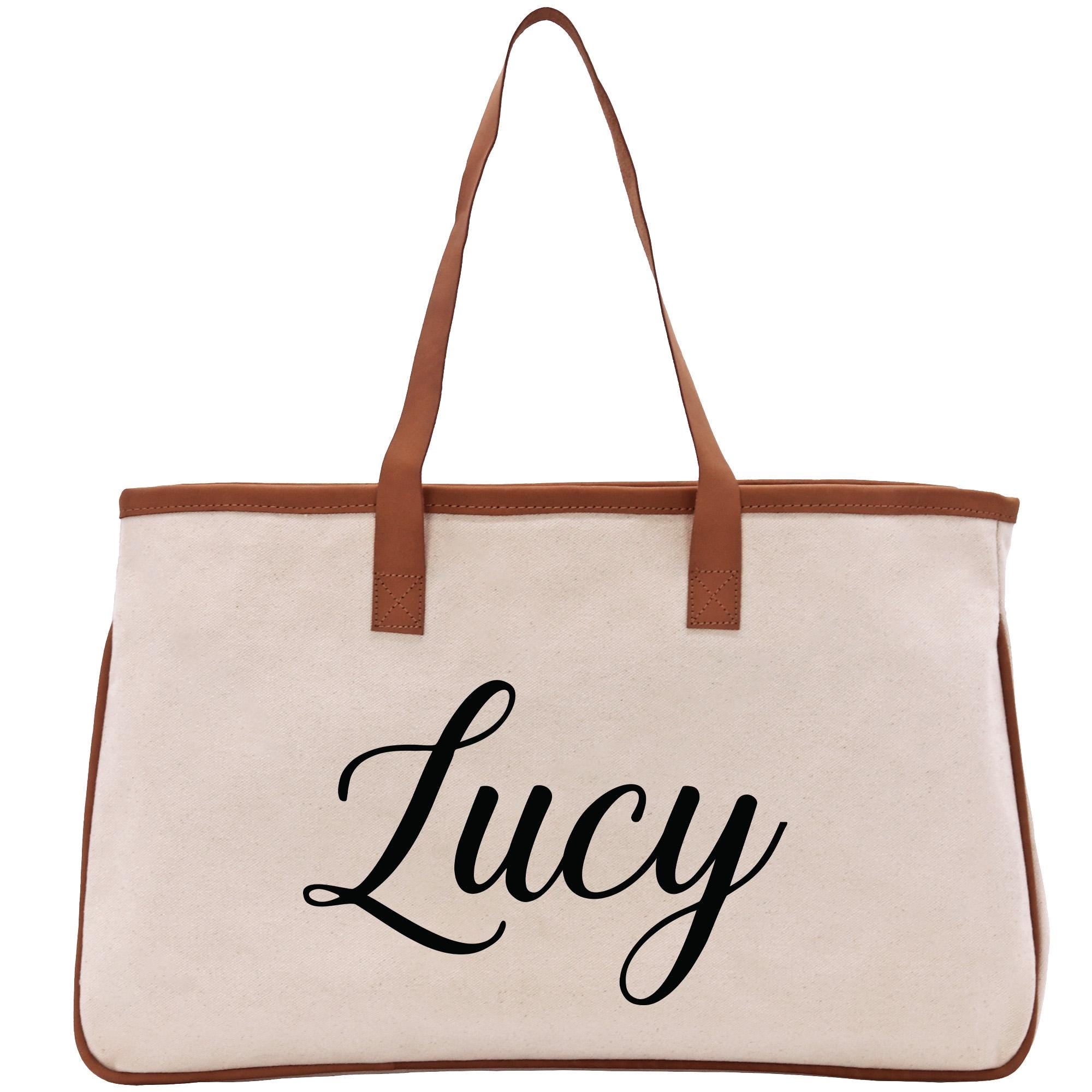 A beige canvas tote bag with the name &quot;Lucy&quot; printed in black cursive text on it.