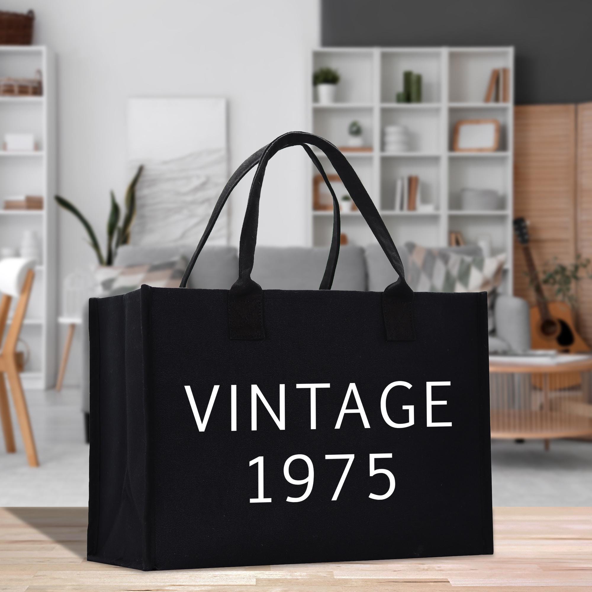 a black shopping bag with the words vintage written on it