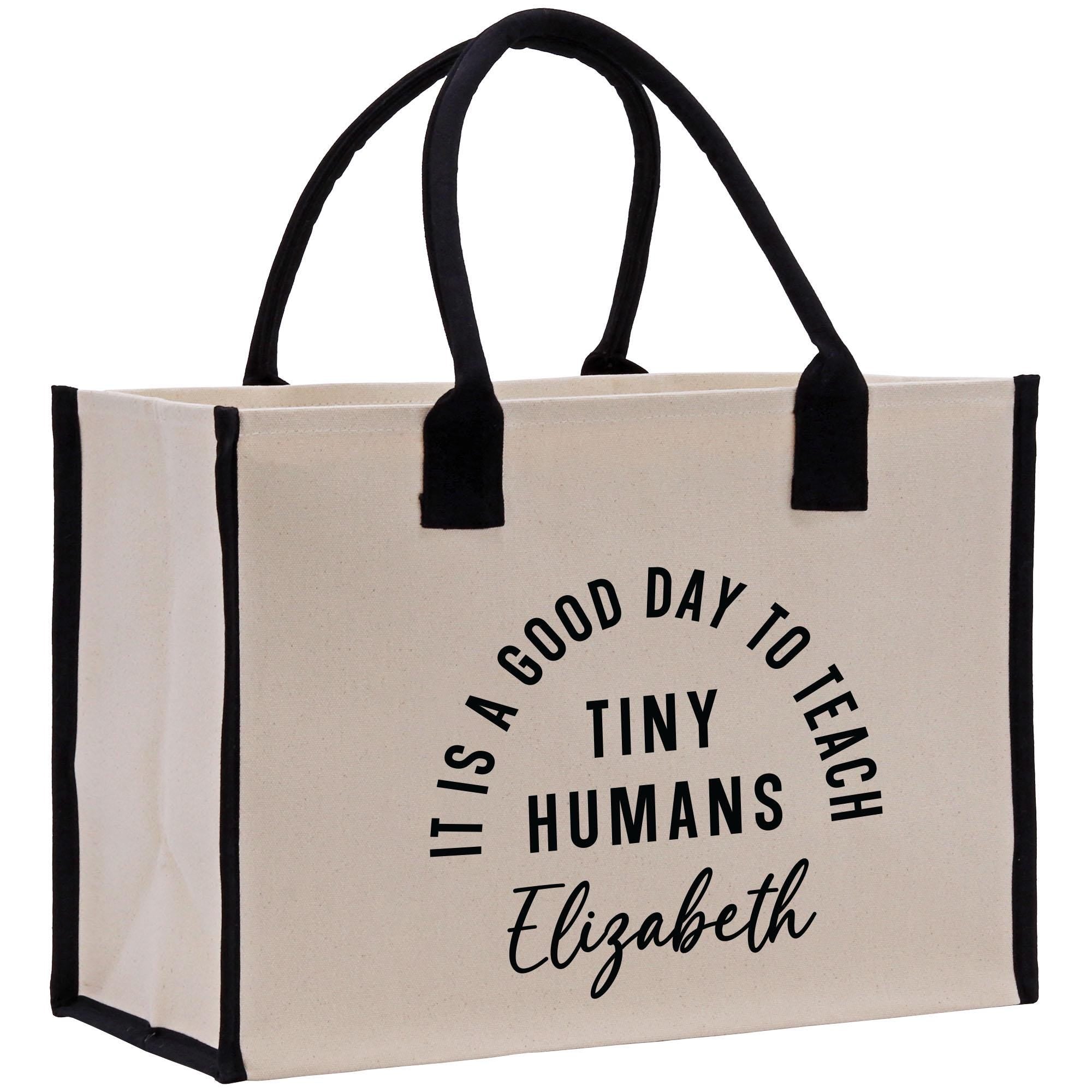 a white bag with black handles that says it&#39;s a good day to teach