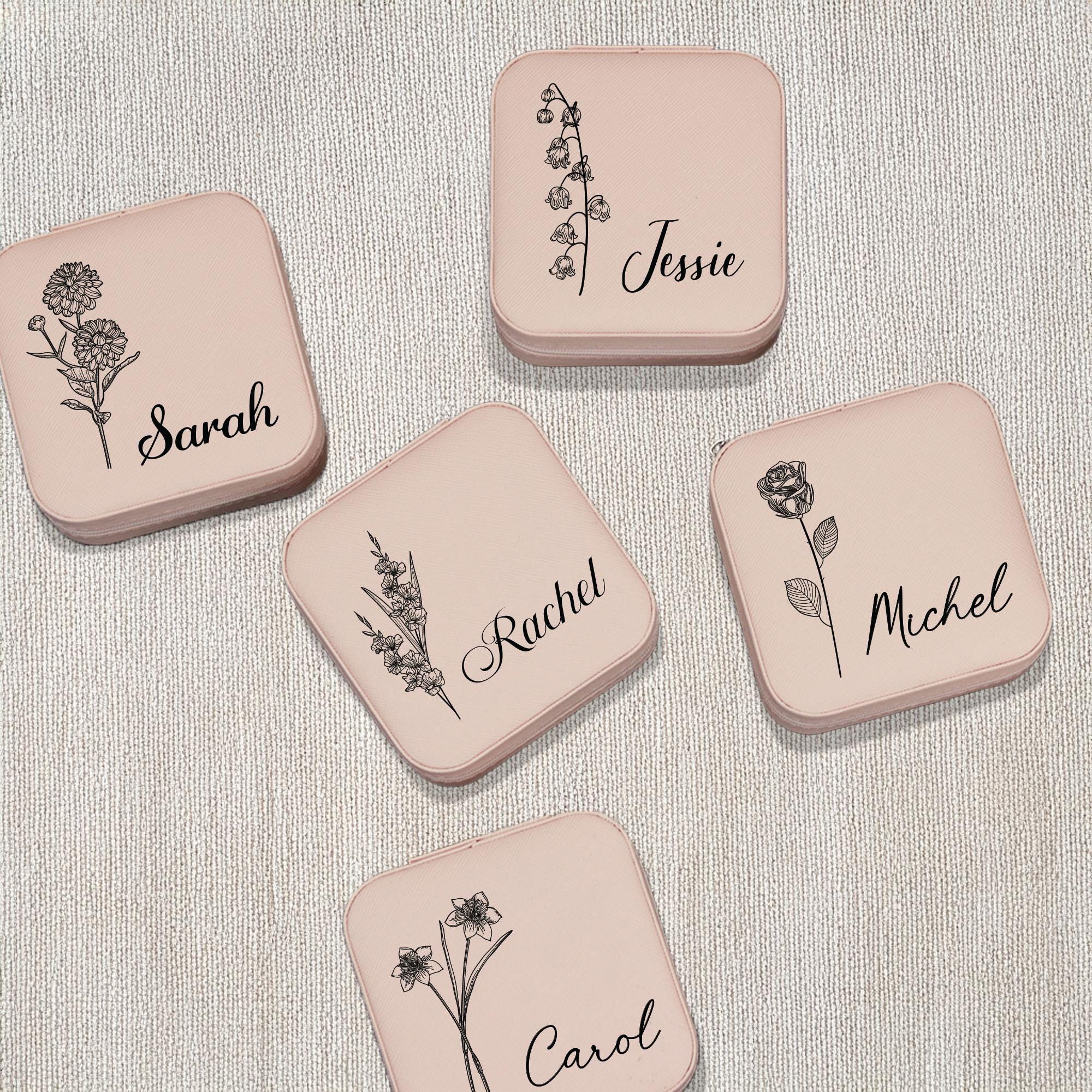 four coasters with flowers on them sitting on a table