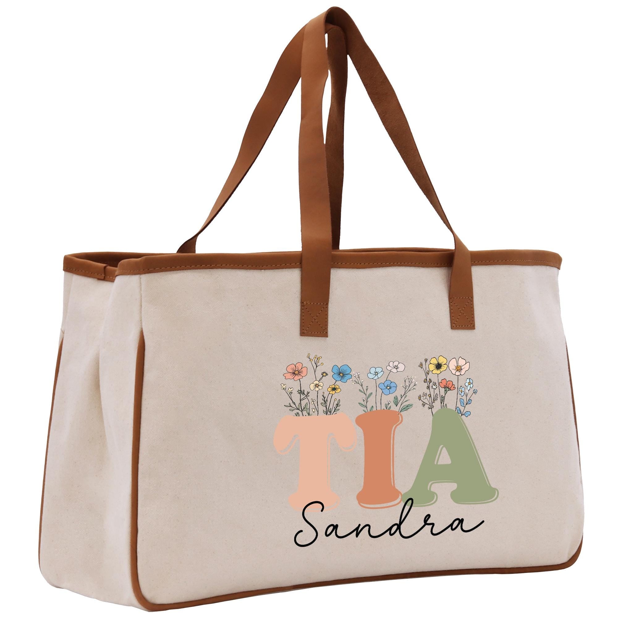 a canvas tote bag with a monogrammed initial