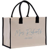 a white and black shopping bag with a name on it