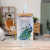 A frosted glass jar with a wooden lid, featuring a colorful illustration of a peacock and the name "Christina" written on it.