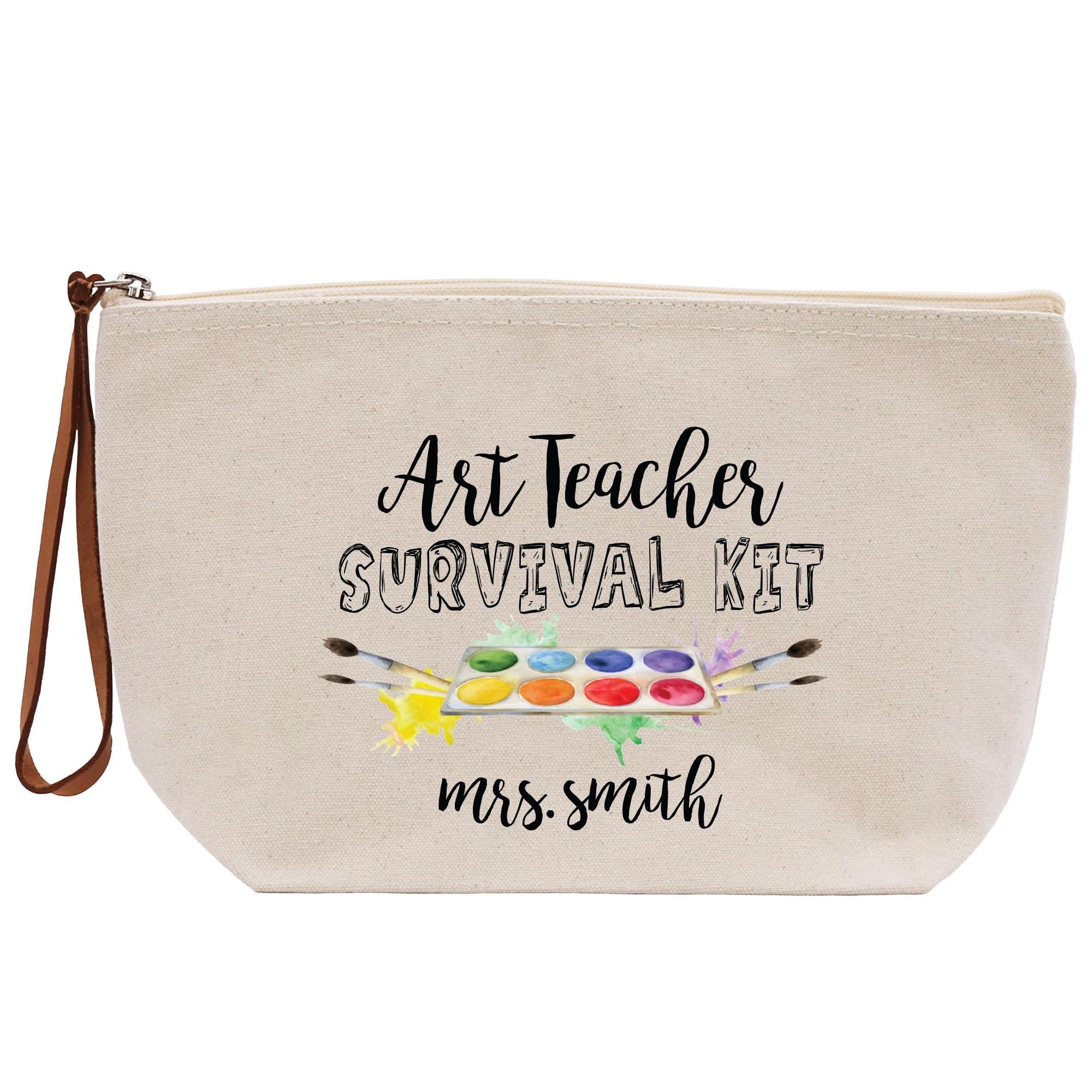 a white canvas bag with the words art teacher survival kit on it