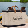 a lake life tote bag sitting on a dock