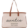 A beige canvas tote bag with brown straps and the text "auntie" printed on it.
