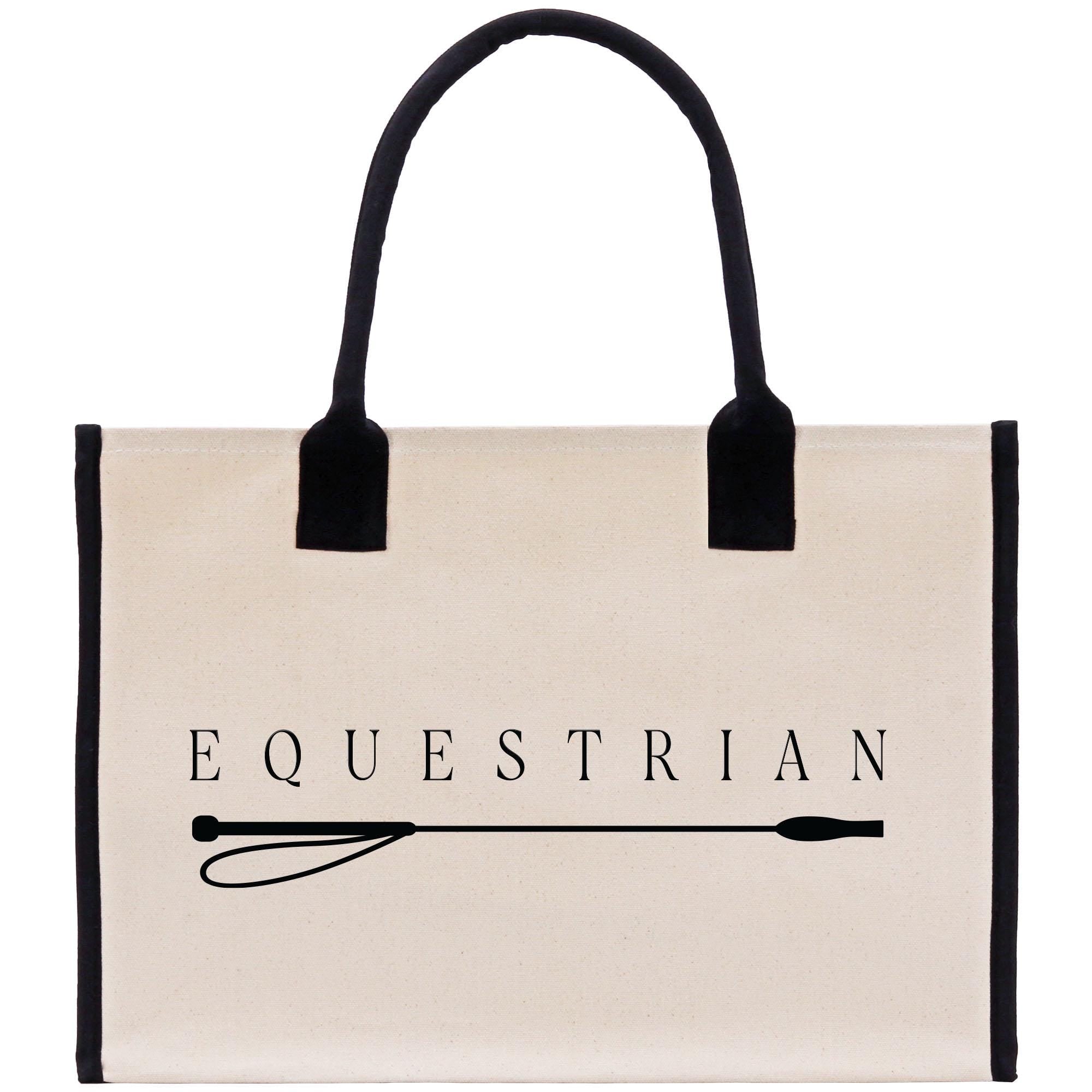 A beige canvas tote bag with the word &quot;EQUESTRIAN&quot; printed on it, along with a black handle and strap.