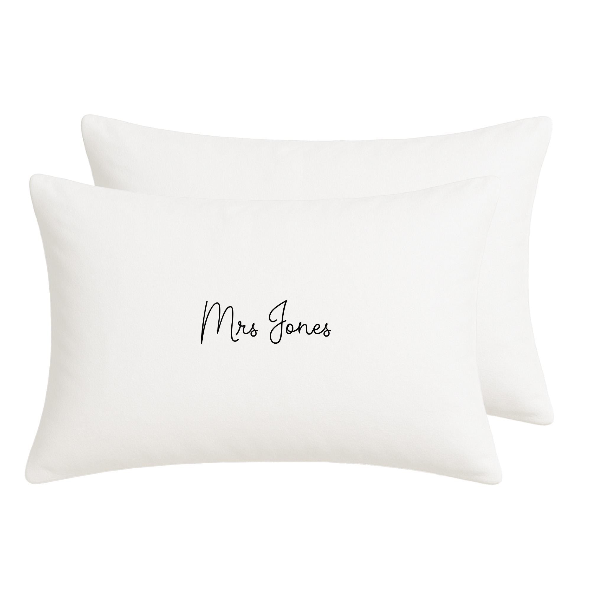 A pair of white rectangular pillows with the text &quot;Mrs Jones&quot; printed on them.