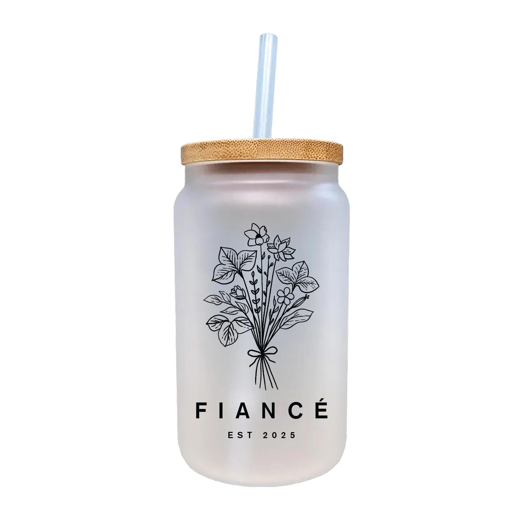 a glass jar with a straw in it