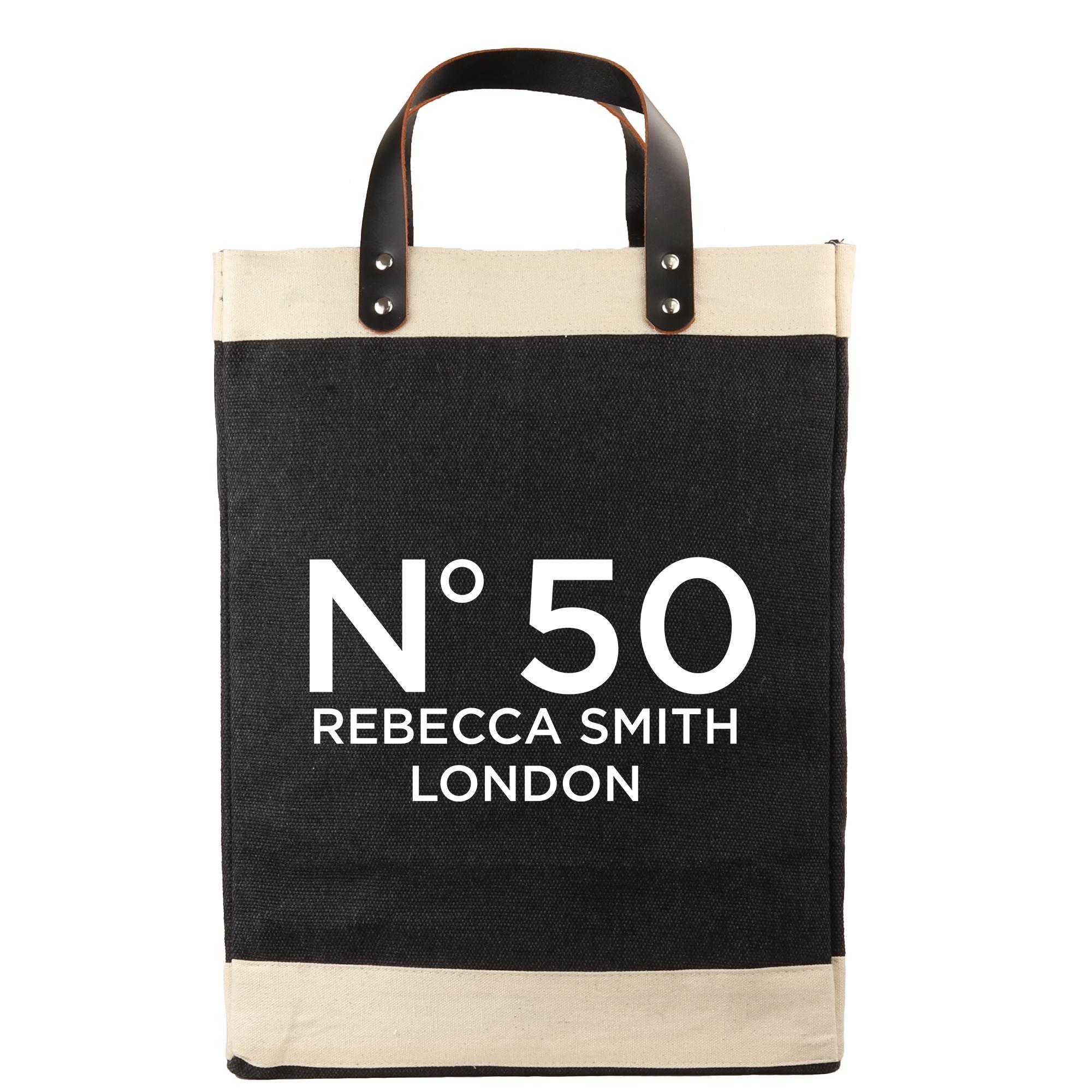 A black and beige tote bag with the text "N°50 Rebecca Smith London" printed on it.
