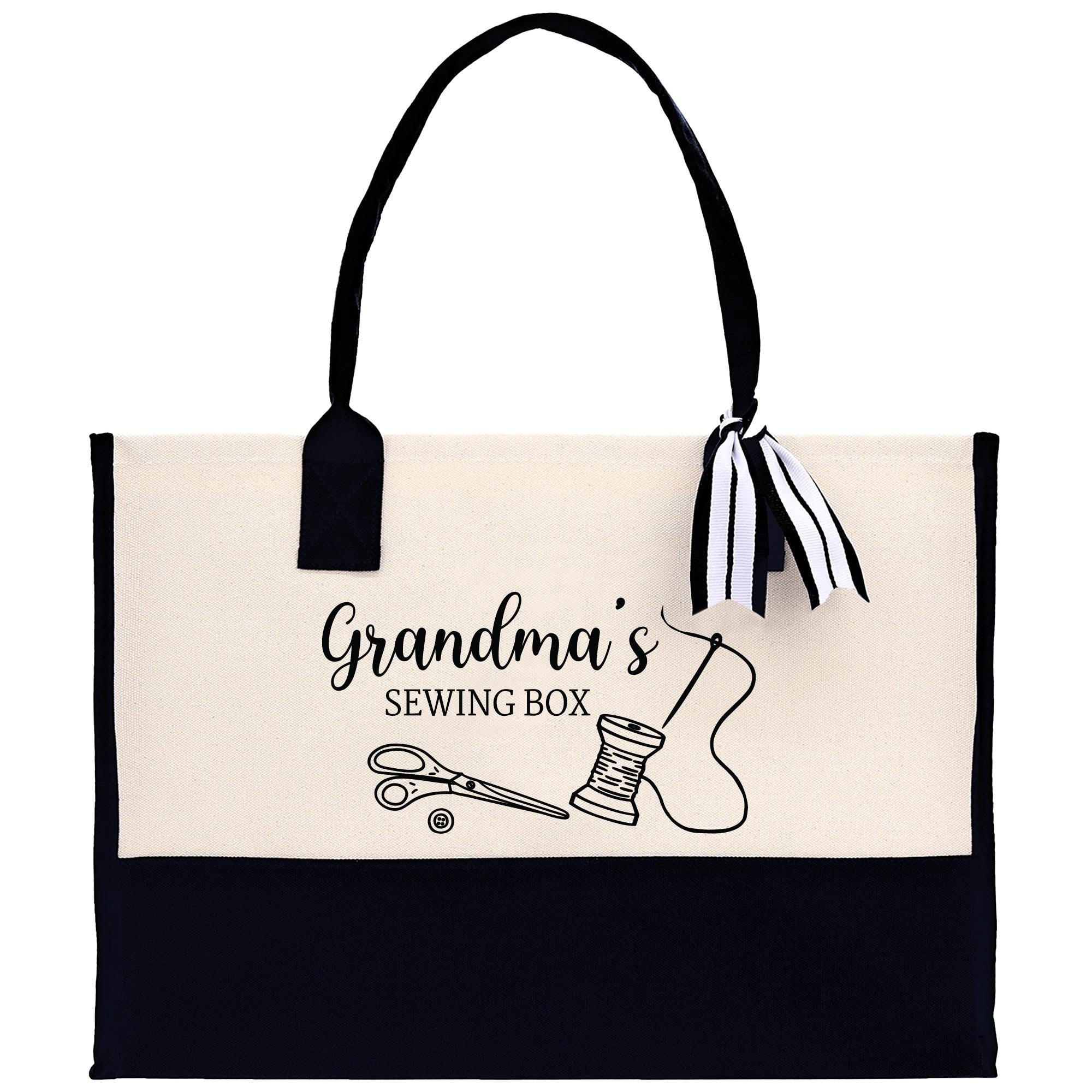 A tote bag with a black and white design featuring sewing-related items such as scissors and a spool of thread, along with the text &quot;Grandma&#39;s Sewing Box&quot;.