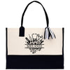 a black and white tote bag with a ribbon