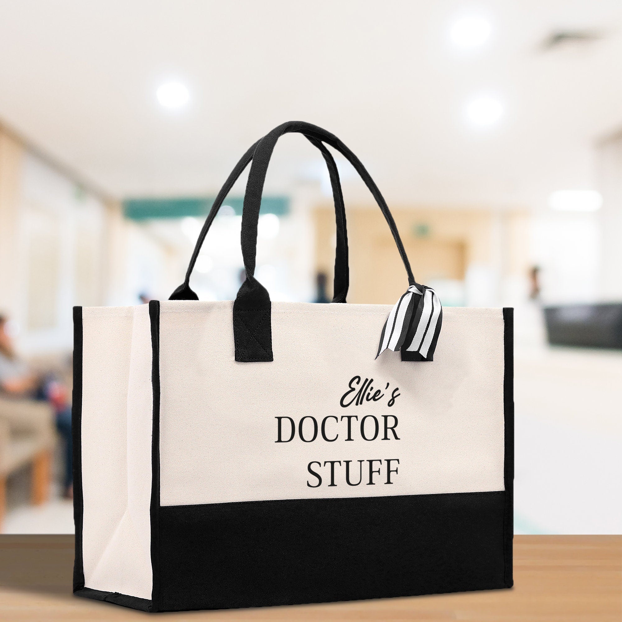 a white and black bag sitting on top of a wooden table