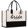 a black and white tote bag with the word bride printed on it