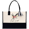 a black and white tote bag with scissors and flowers