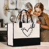 a woman holding a shopping bag with a heart drawn on it