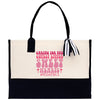 a black and white tote bag with pink lettering