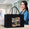 a woman holding a black shopping bag with the words pediatric nurse in progress on it