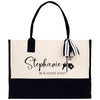 a black and white tote bag with a name tag