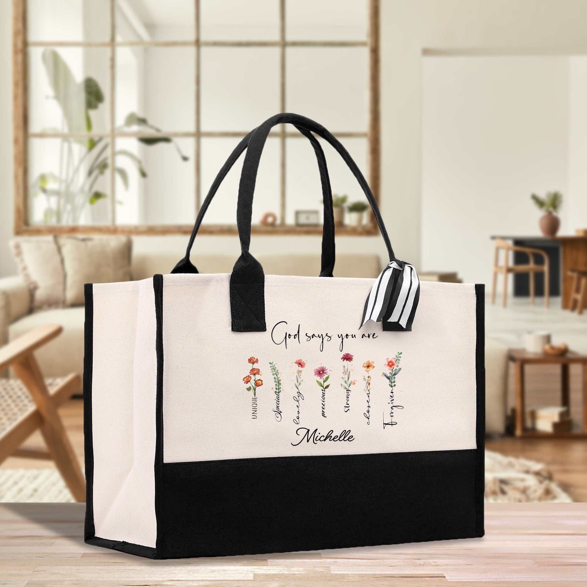 a black and white shopping bag with flowers on it