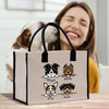a woman holding a shopping bag with dogs on it