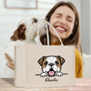 a woman holding a shopping bag with a dog on it
