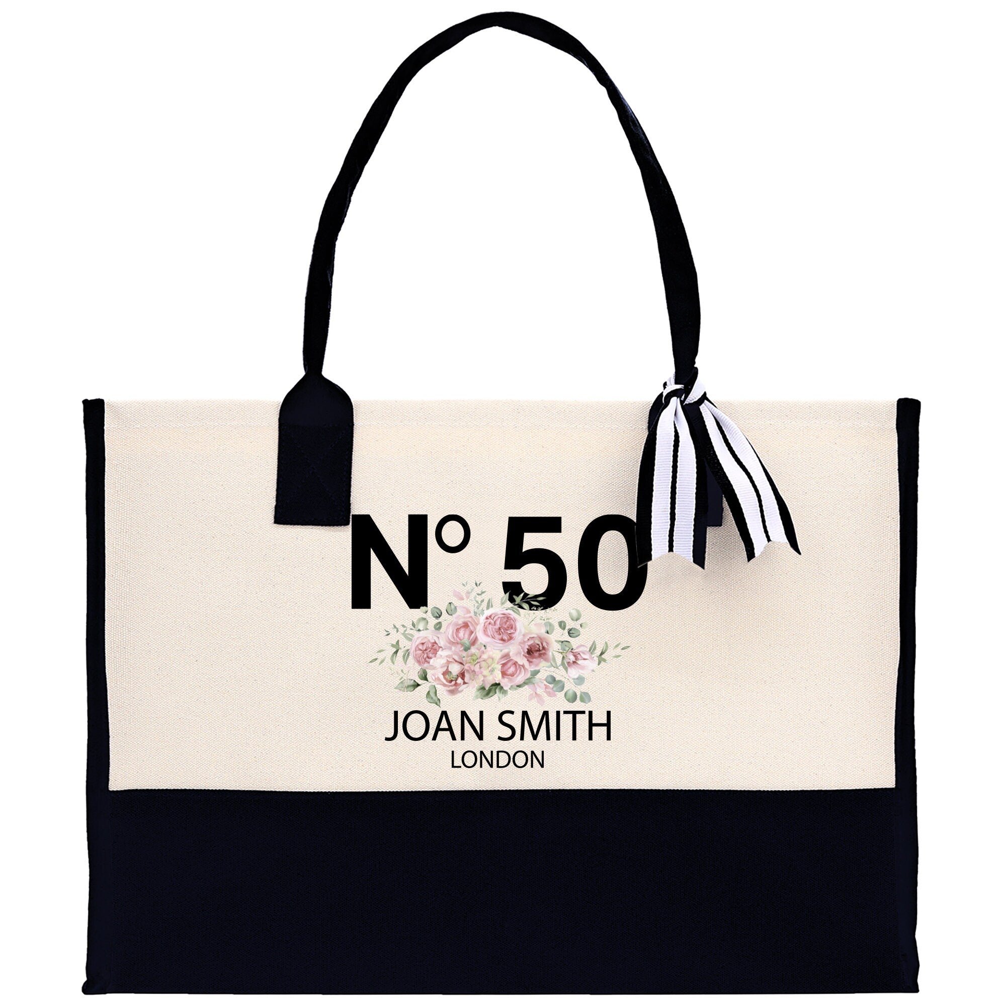 a black and white tote bag with a bow on it