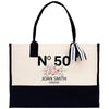 a black and white tote bag with a bow on it