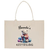 a tote bag with a teddy bear holding a yarn ball