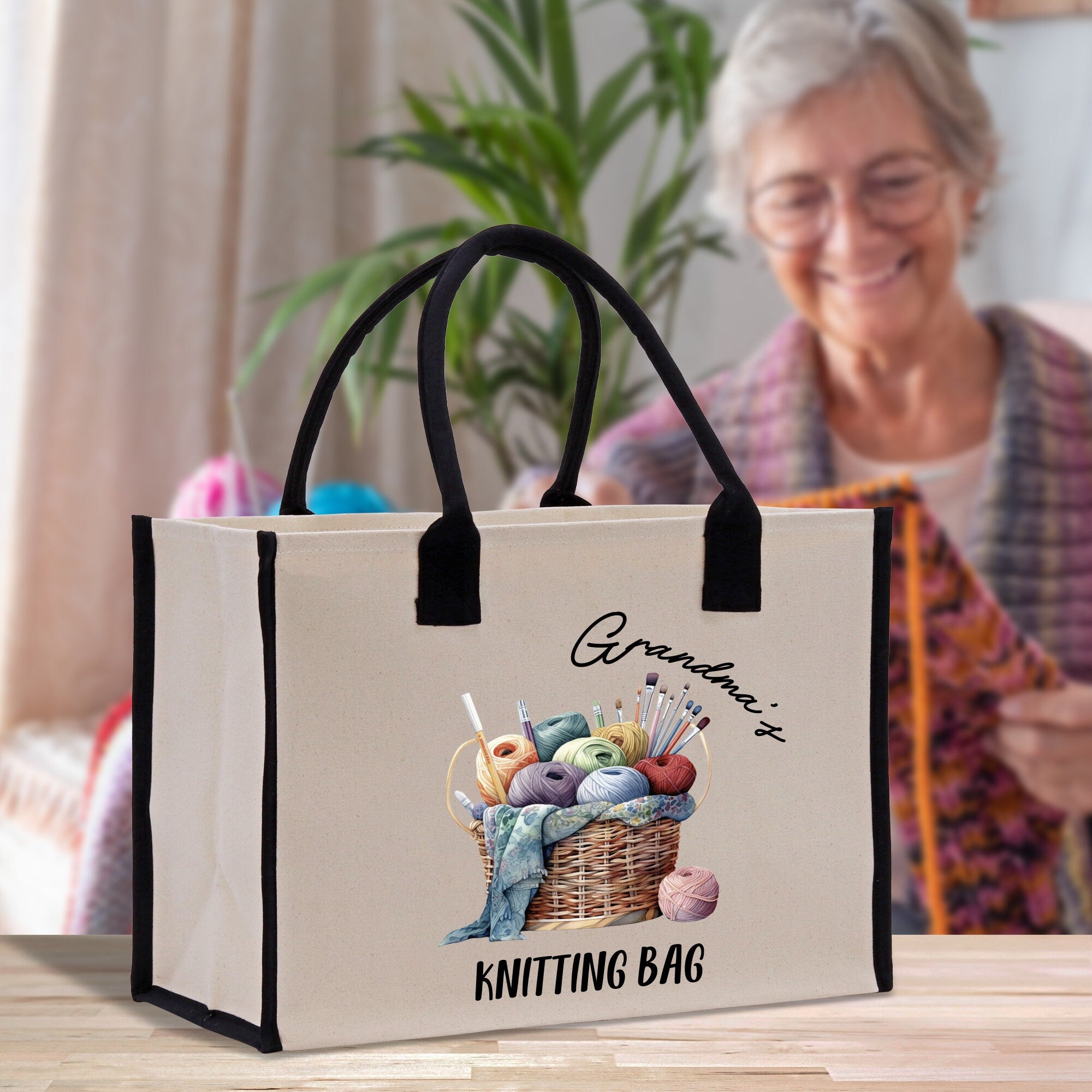 a woman sitting at a table with a knitting bag