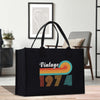 a black shopping bag with a vintage design on it