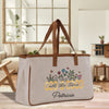 a canvas bag with embroidered words and flowers