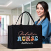a woman holding a black bag with the words pediatric nurse on it