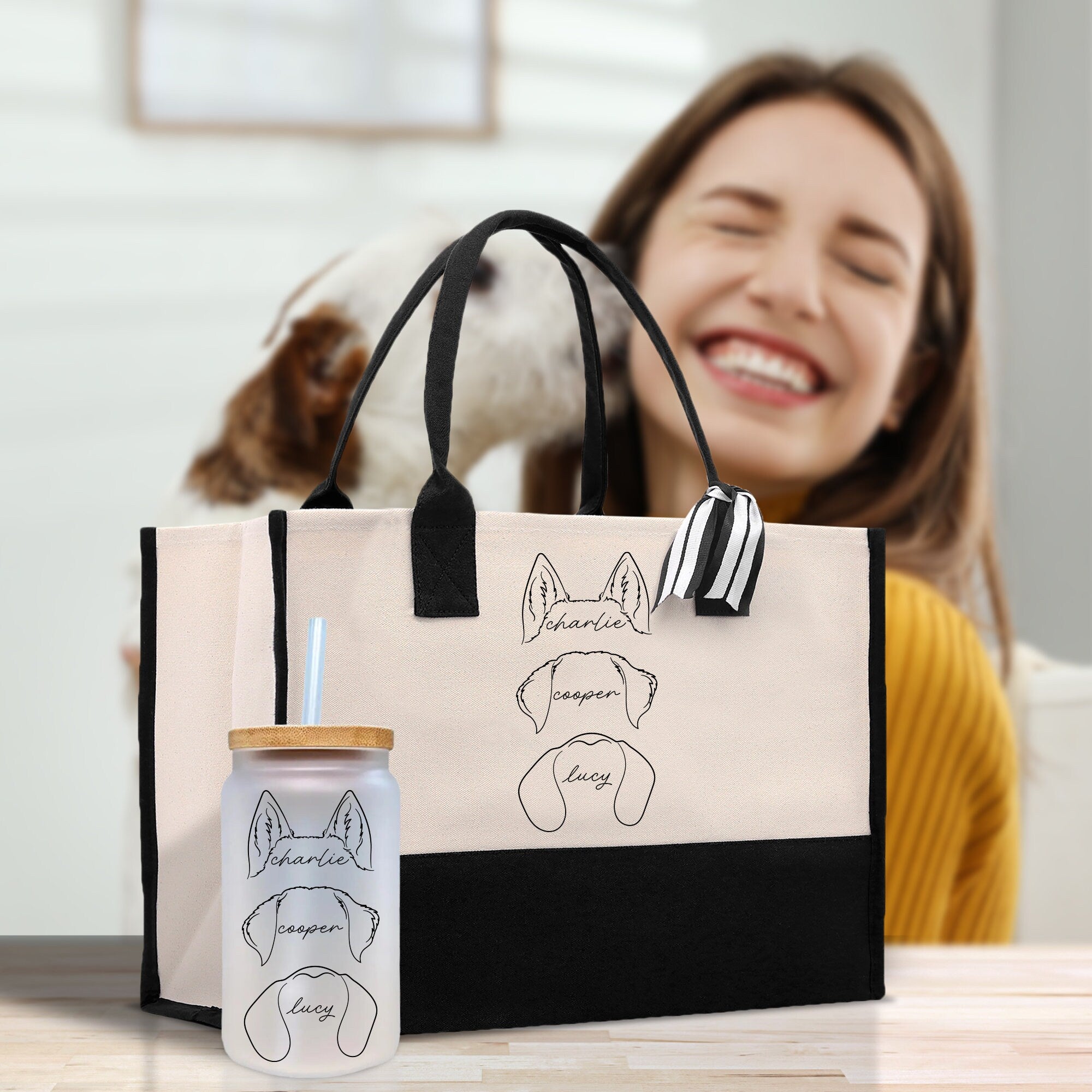 a woman sitting at a table with a dog and a bag