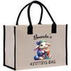 a shopping bag with a picture of a bunny holding a knitting bag