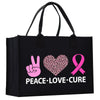 a black shopping bag with a pink heart and peace love cure on it