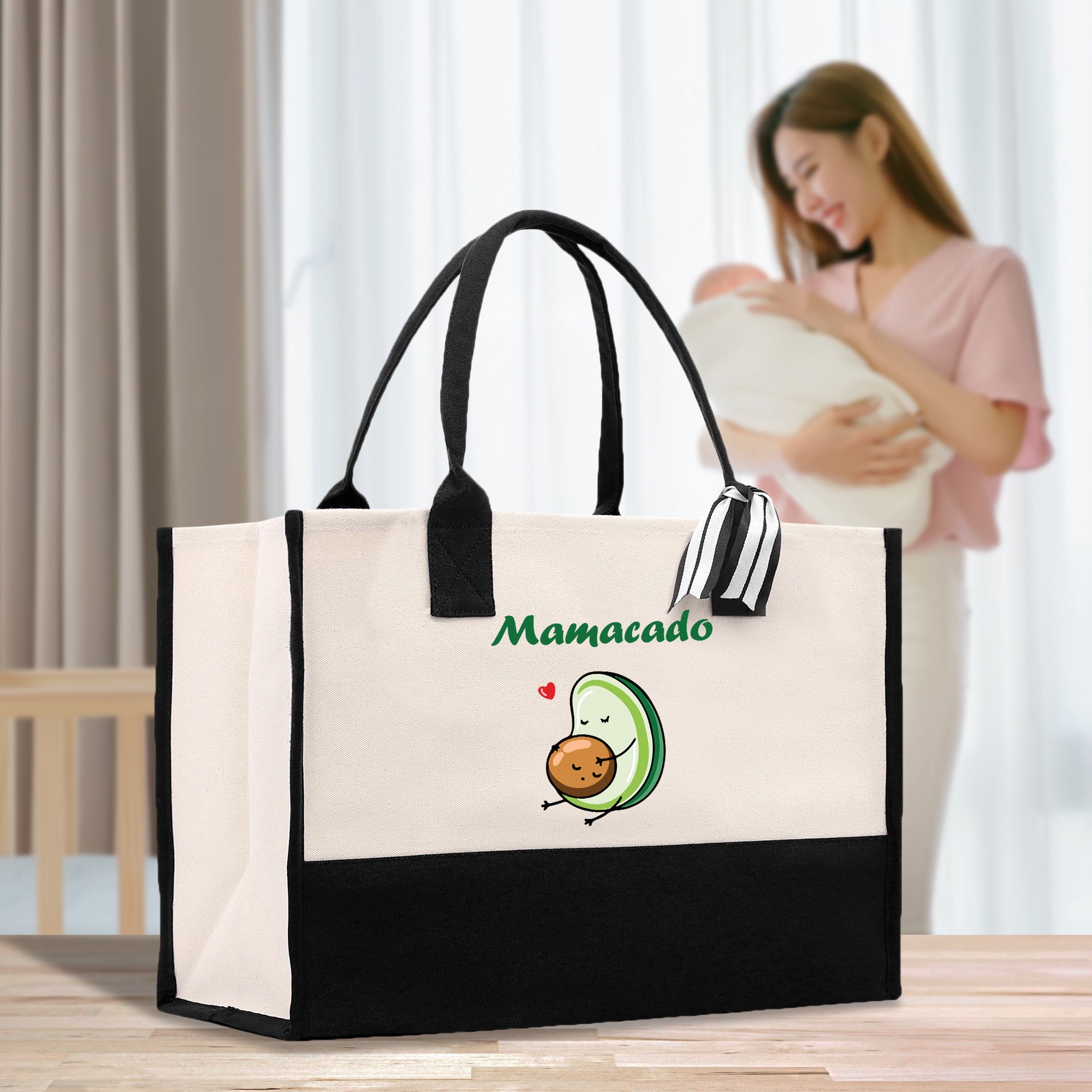 a woman holding a baby in a black and white bag