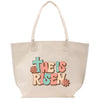 a white tote bag with a cross on it