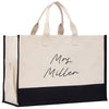 a black and white shopping bag with writing on it