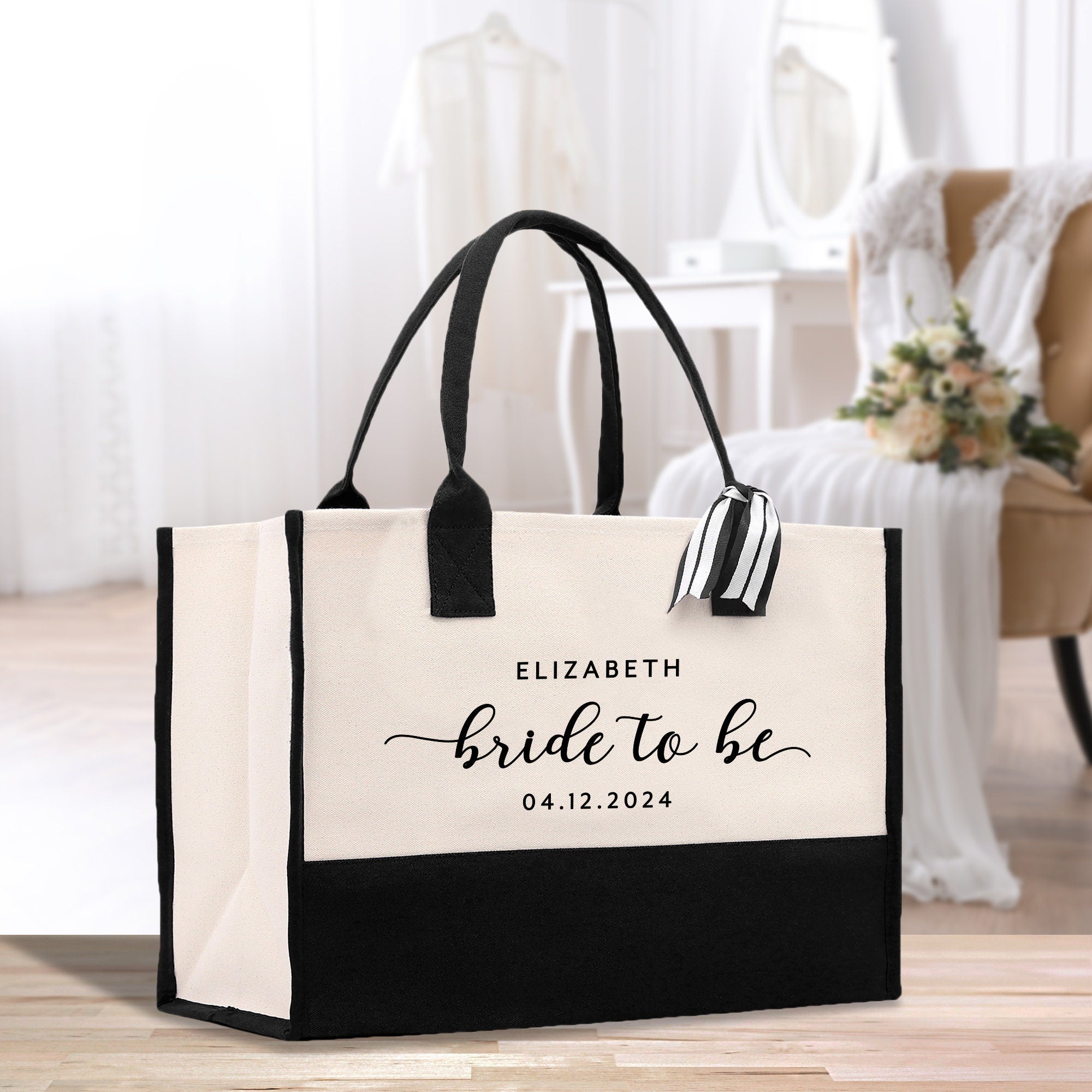 a black and white bag with a bride to be on it