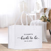 a bride to be bag sitting on a wooden floor