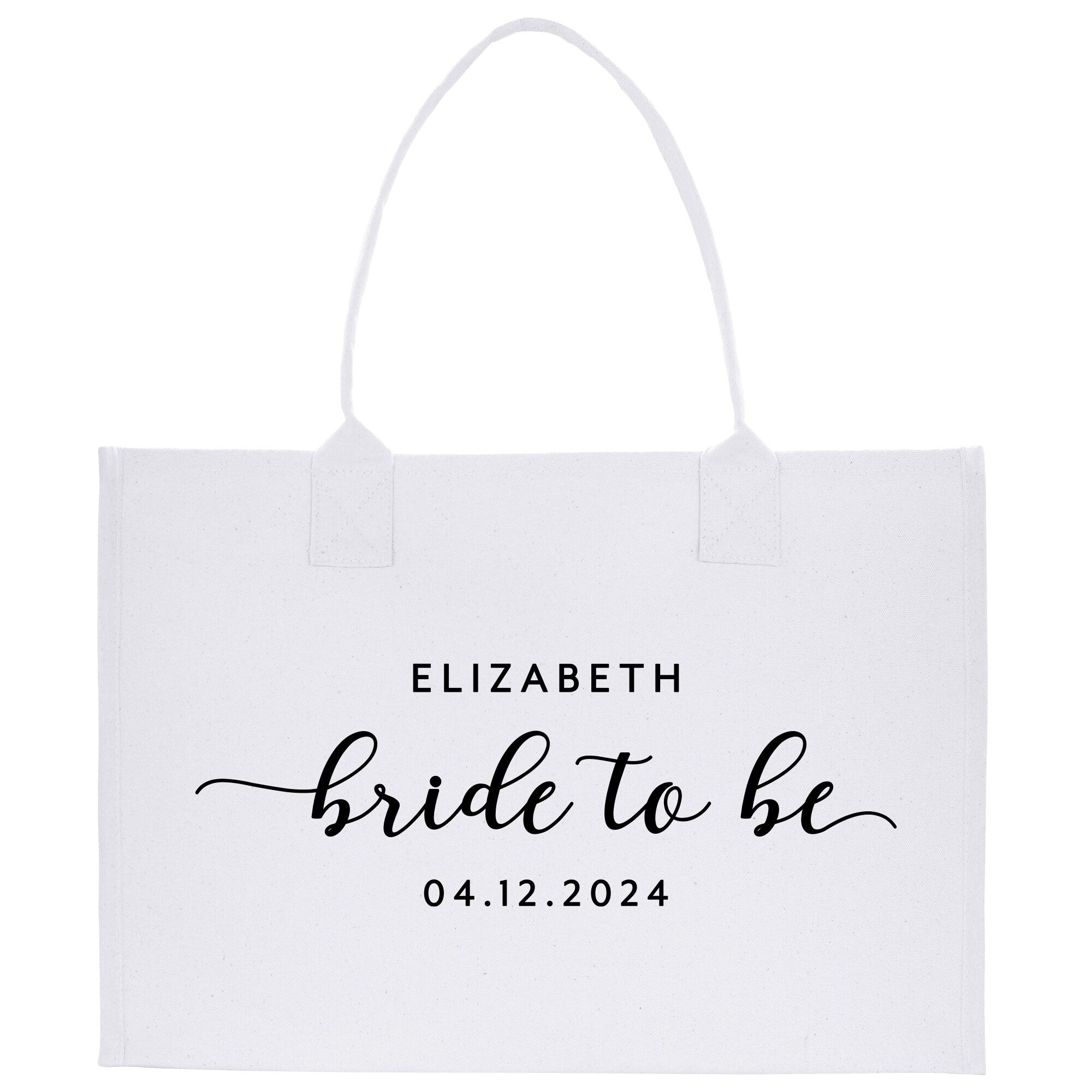 a white tote bag with the words bride to be printed on it