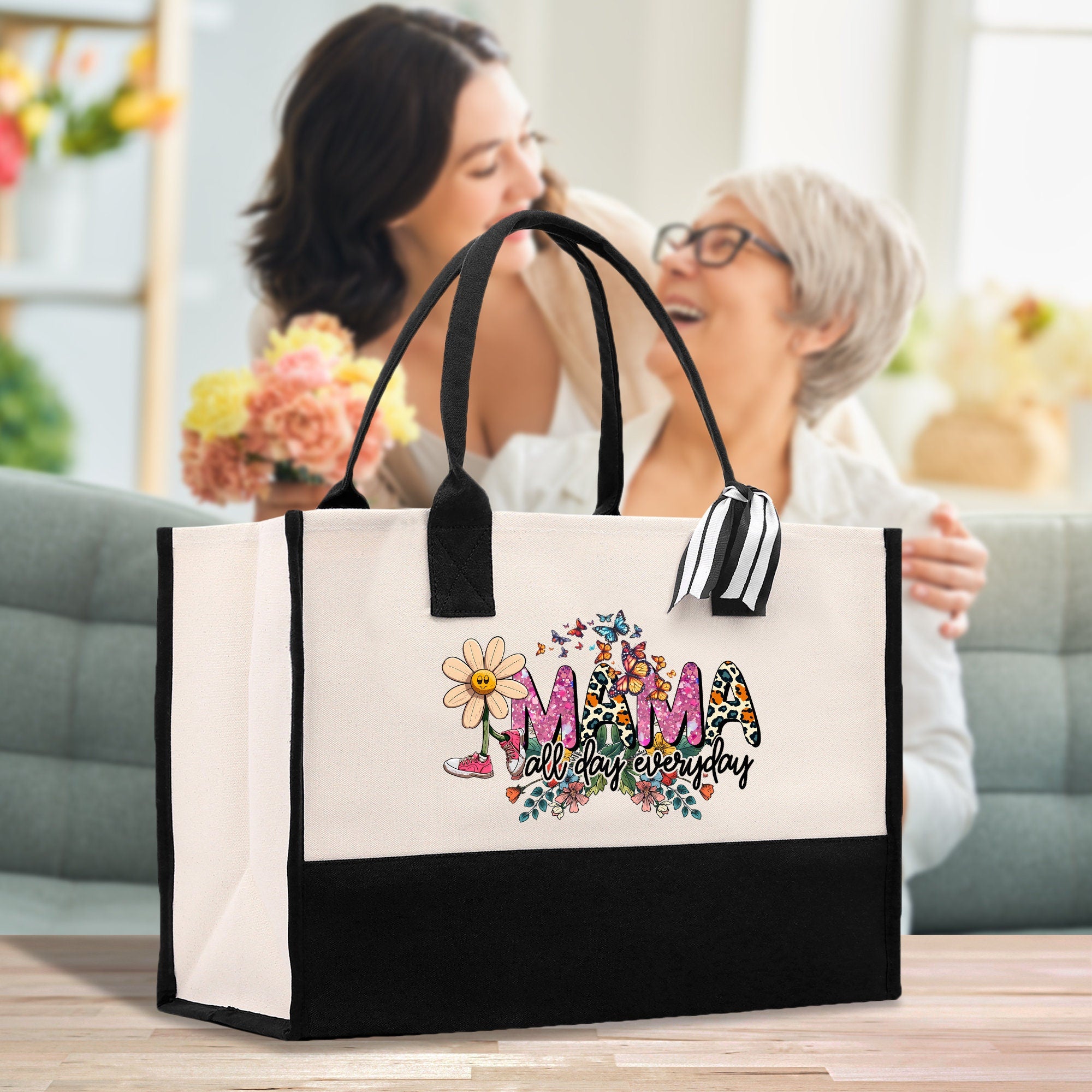a woman holding a shopping bag with the word mom on it