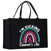 a black shopping bag with a pink ribbon on it