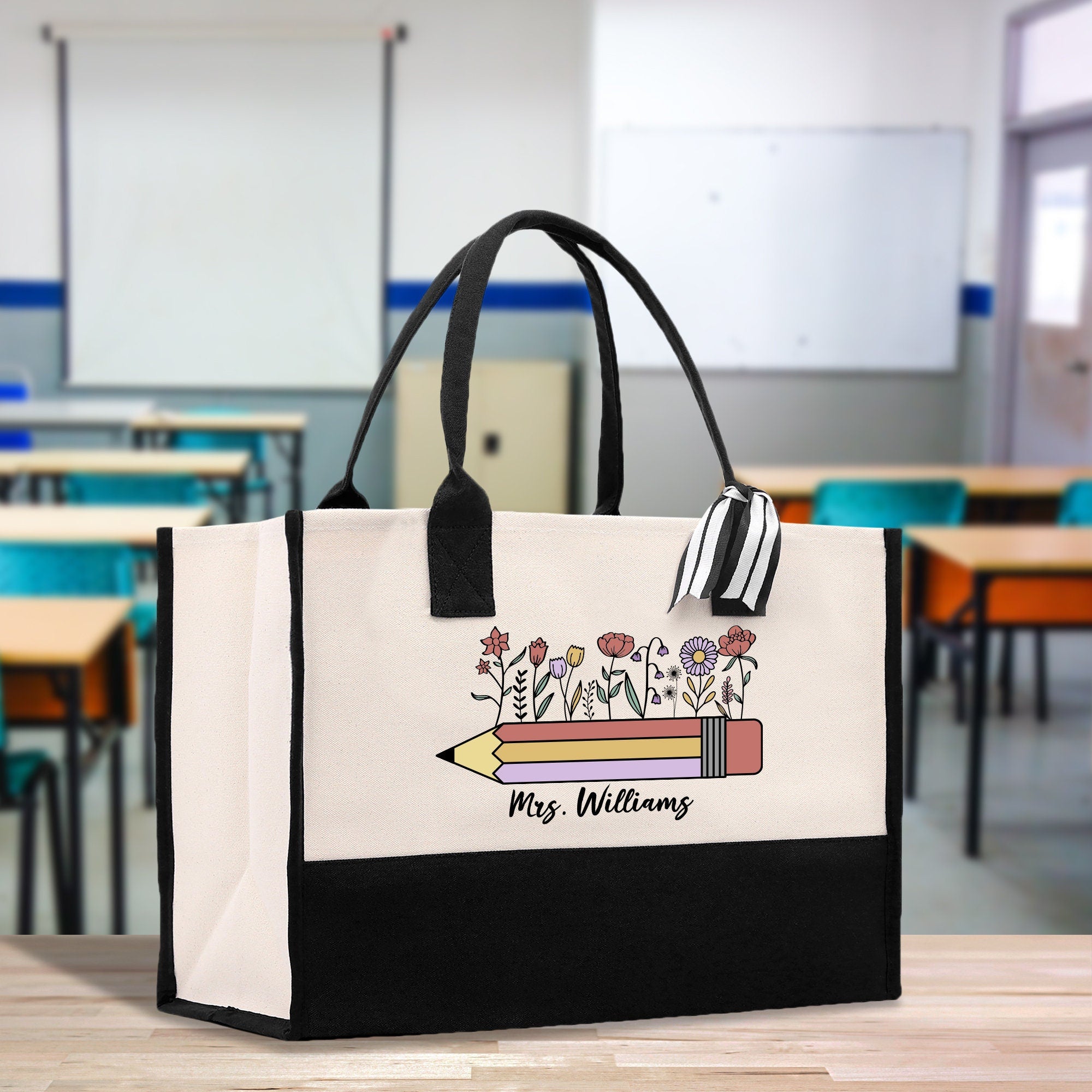 a black and white bag with a picture of a pencil on it