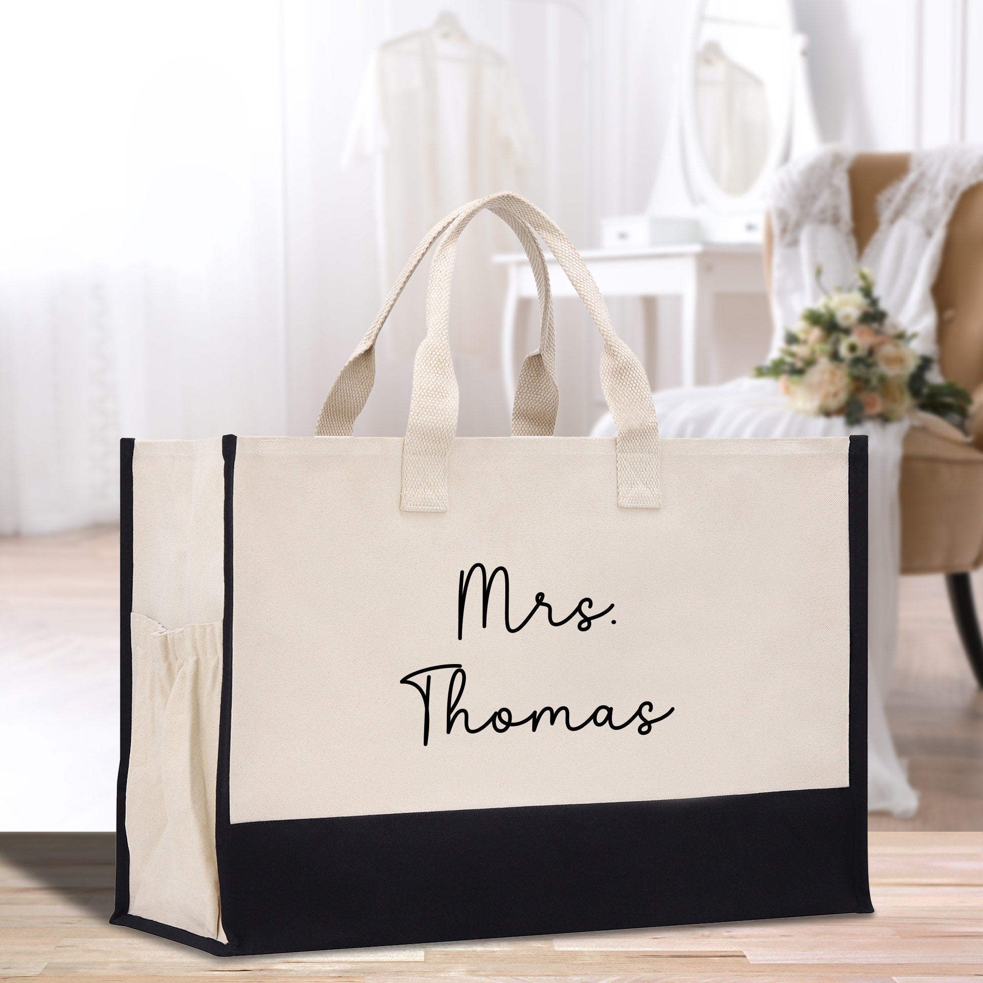 a black and white bag with the words mrs thomas on it